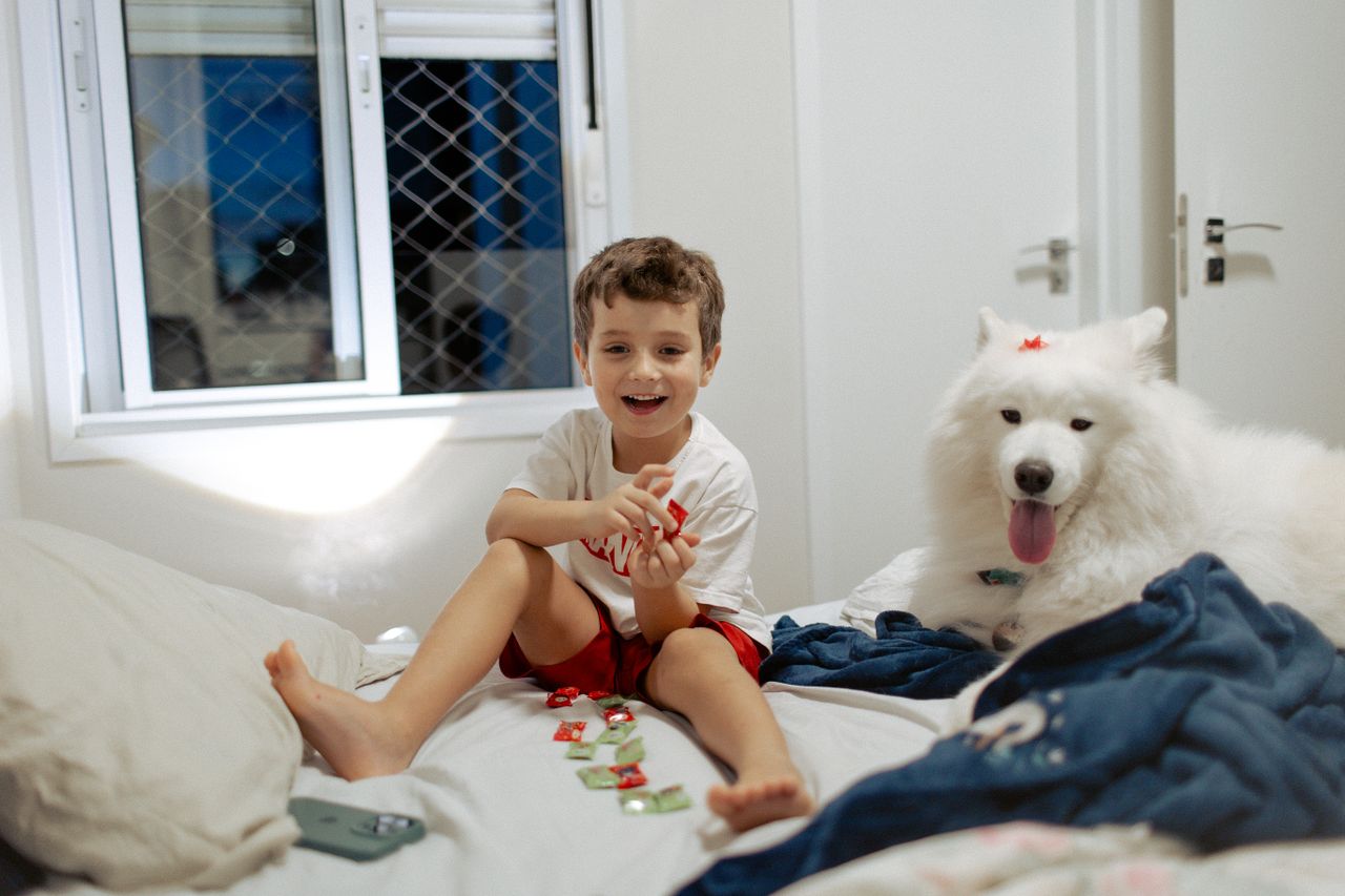 Children playing an educational card game inside, focusing on activity and learning.